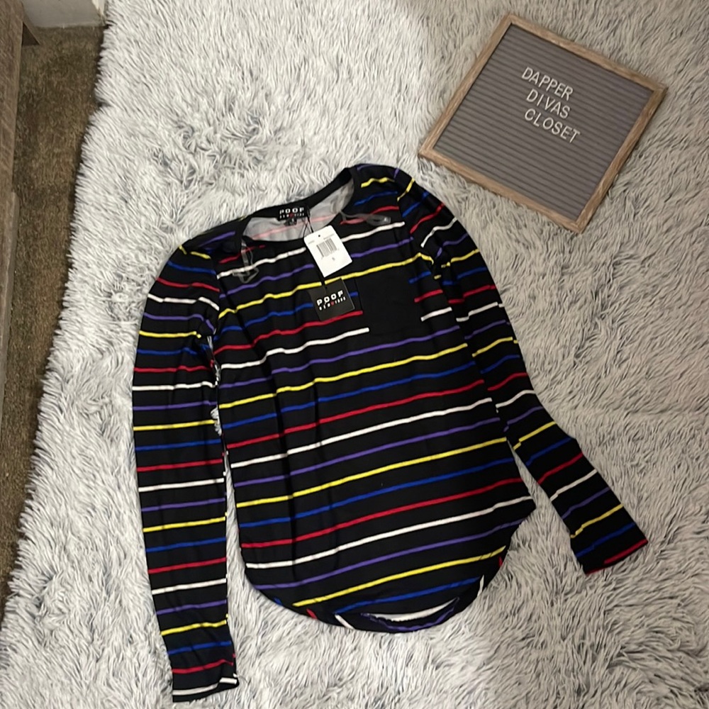 Long sleeve black top with multi-color stripes and a small pocket